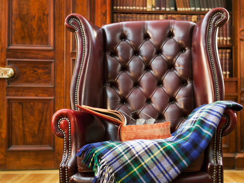 Herreværelset med en blød lænestol med et tæppe og en bog